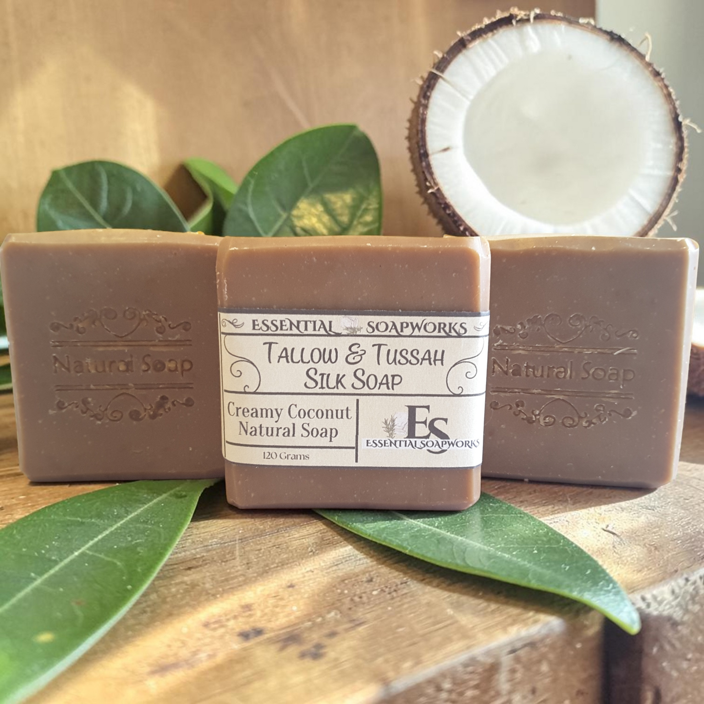 coconut tallow soap bars on a wooden surface with a slice of coconut