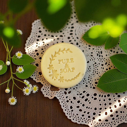 Bar of Natural Facial Soap on a lace doily with greenery around.