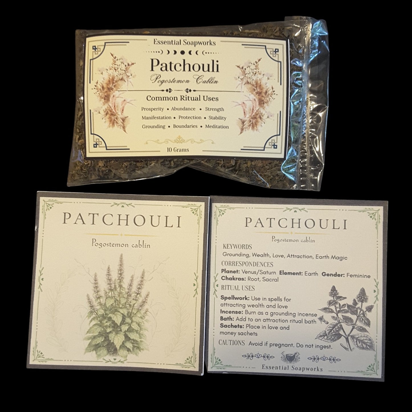 Two square product cards for Patchouli by Essential Soapworks are arranged on a black background, with a clear plastic bag of dried patchouli buds above them. The cards show botanical illustrations and text including common ritual uses, keywords, and cautions.