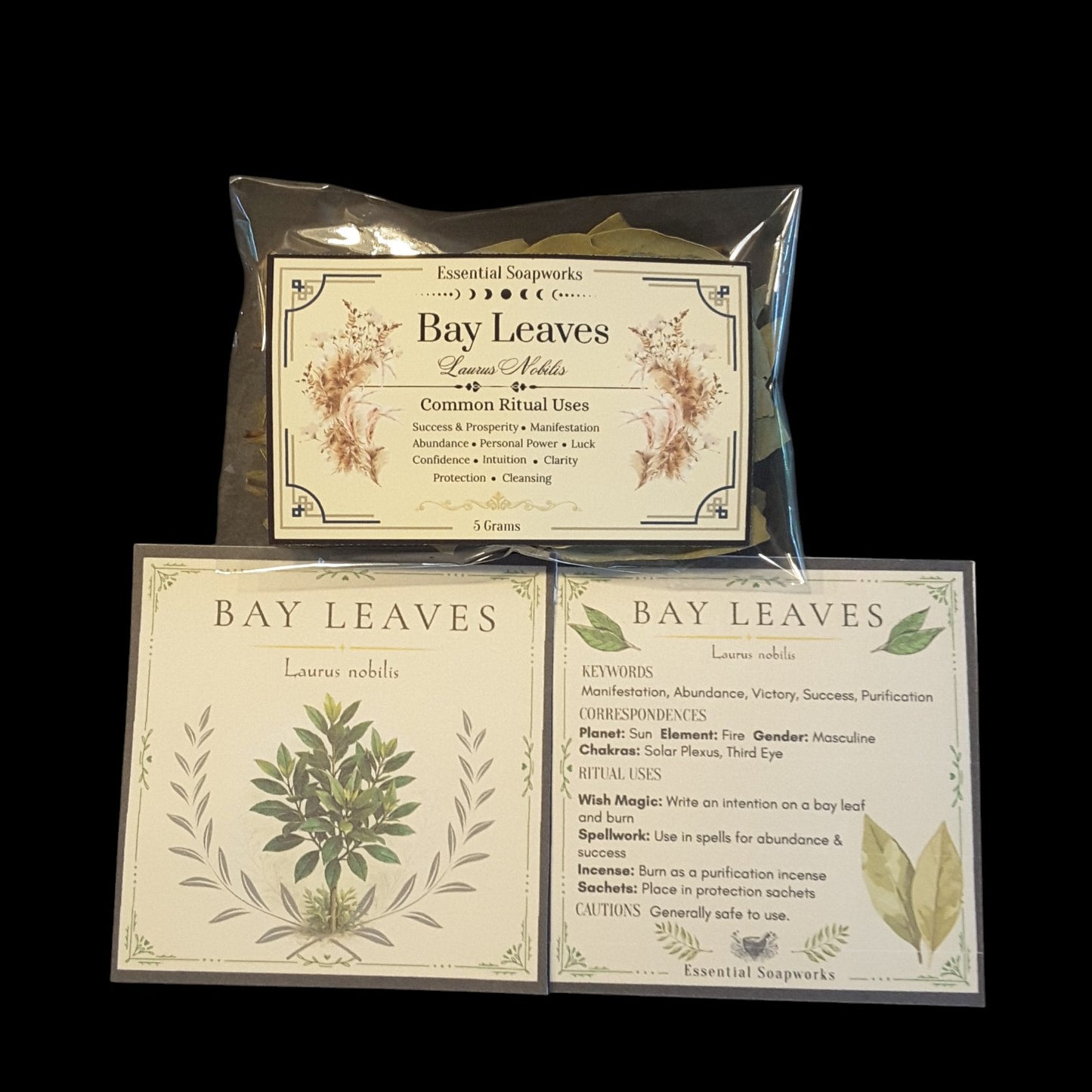 Two square product cards for Bay Leaves by Essential Soapworks, displayed on a black background shown flat with printed botanical illustrations and text about spiritual uses, key words, planets, and chakras.