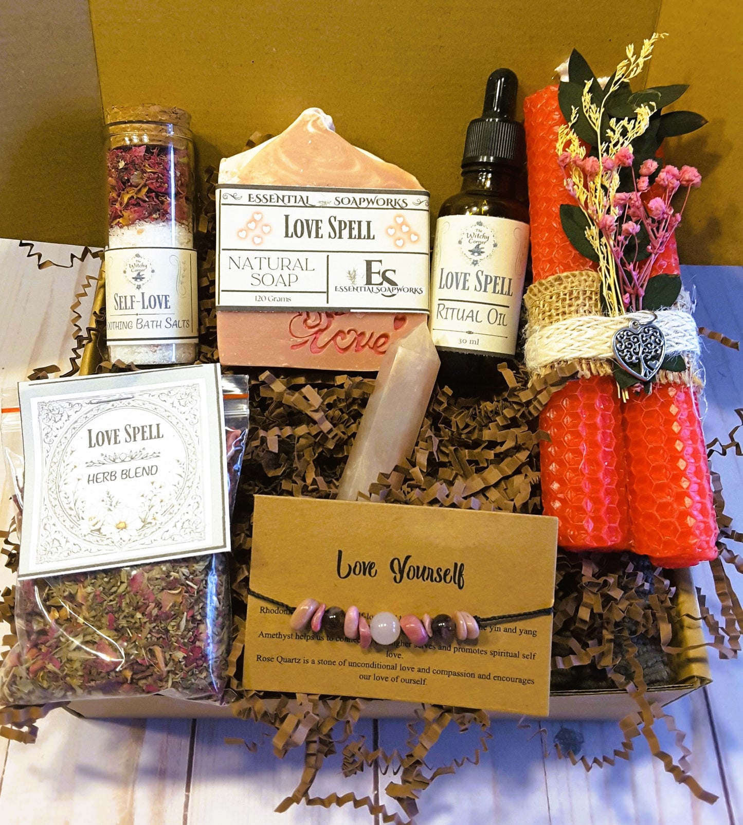 witchy self-care ritual kit including soap, candles, and essential oils on a wooden surface.