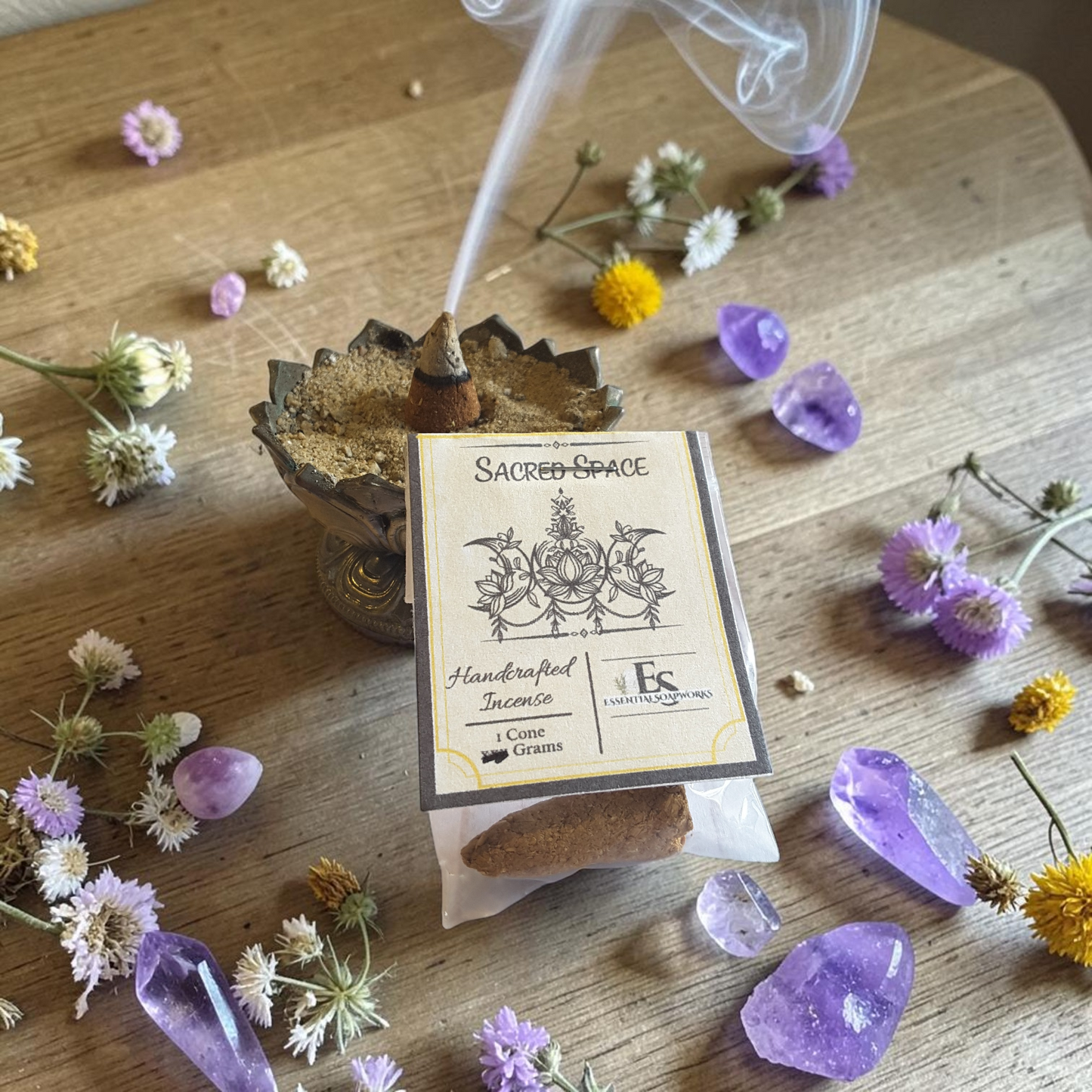 handmade sacred space incense cones on a wooden surface surrounded by flowers and crystals