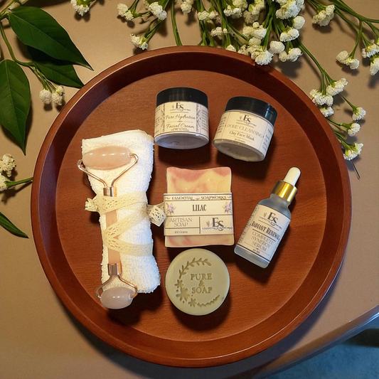 a group of skincare products on a wooden tray with white flowers and green leaves