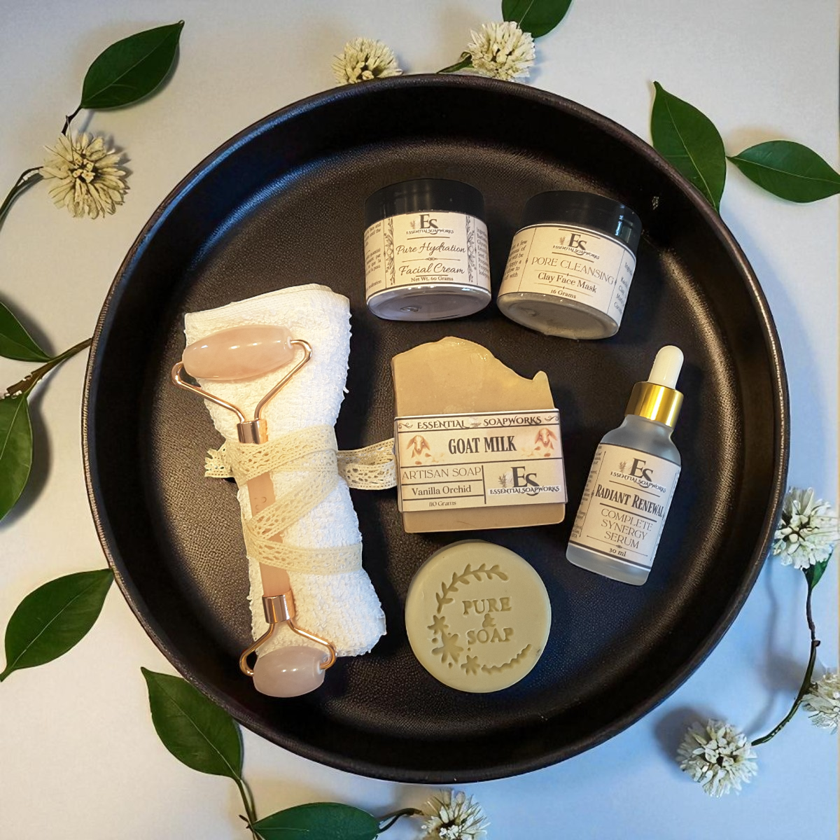 a group of skincare items on a black tray with green leaves and white flowers