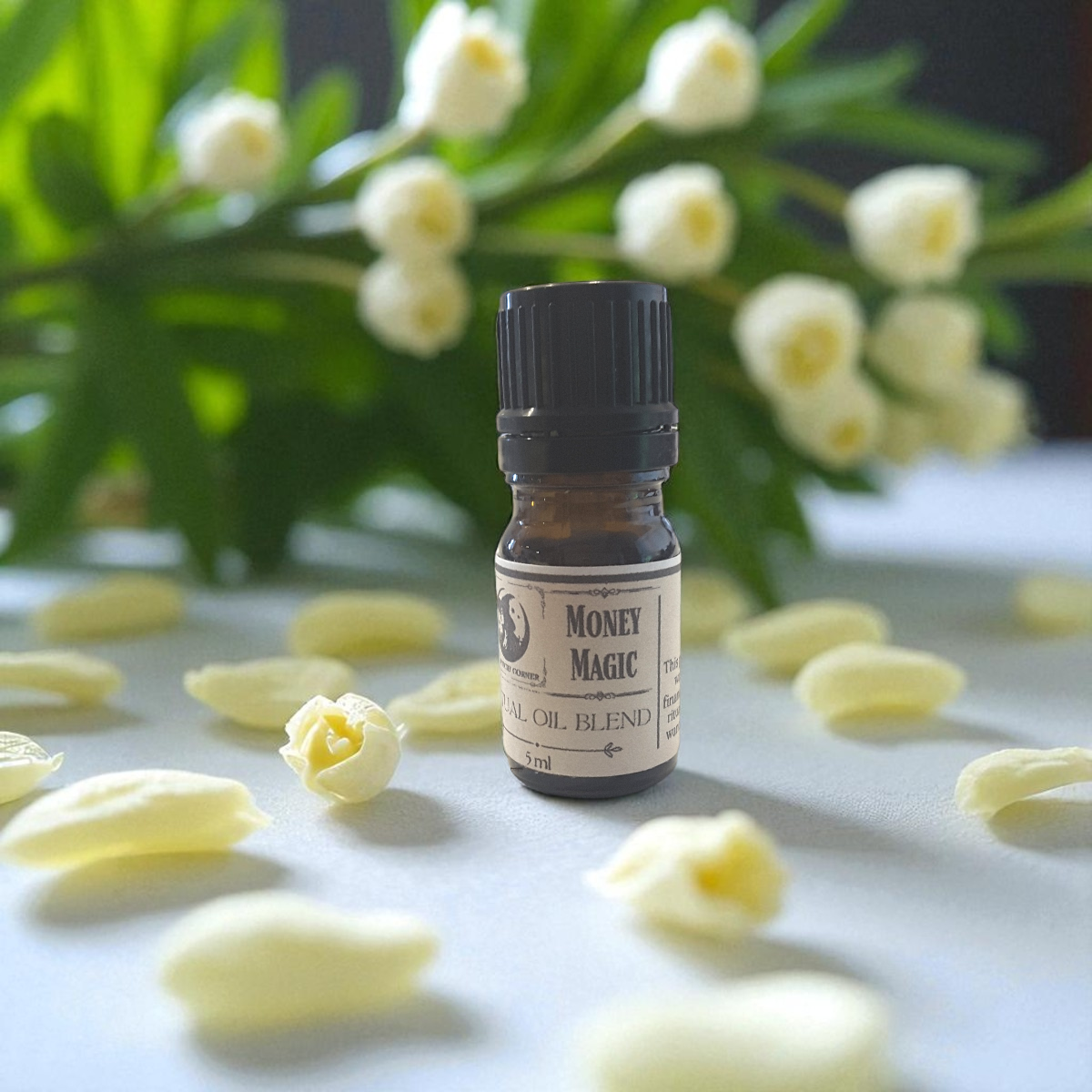 Money Magic ritual oil surrounded by yellow flowers on a light surface.
