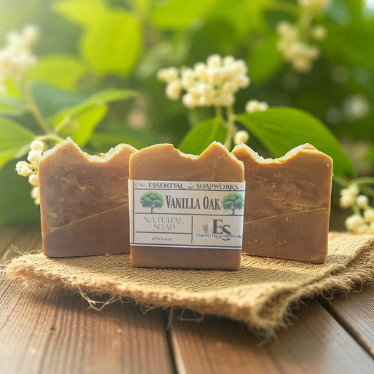 Three bars of Vanilla Oak soap on a wooden surface with a natural background