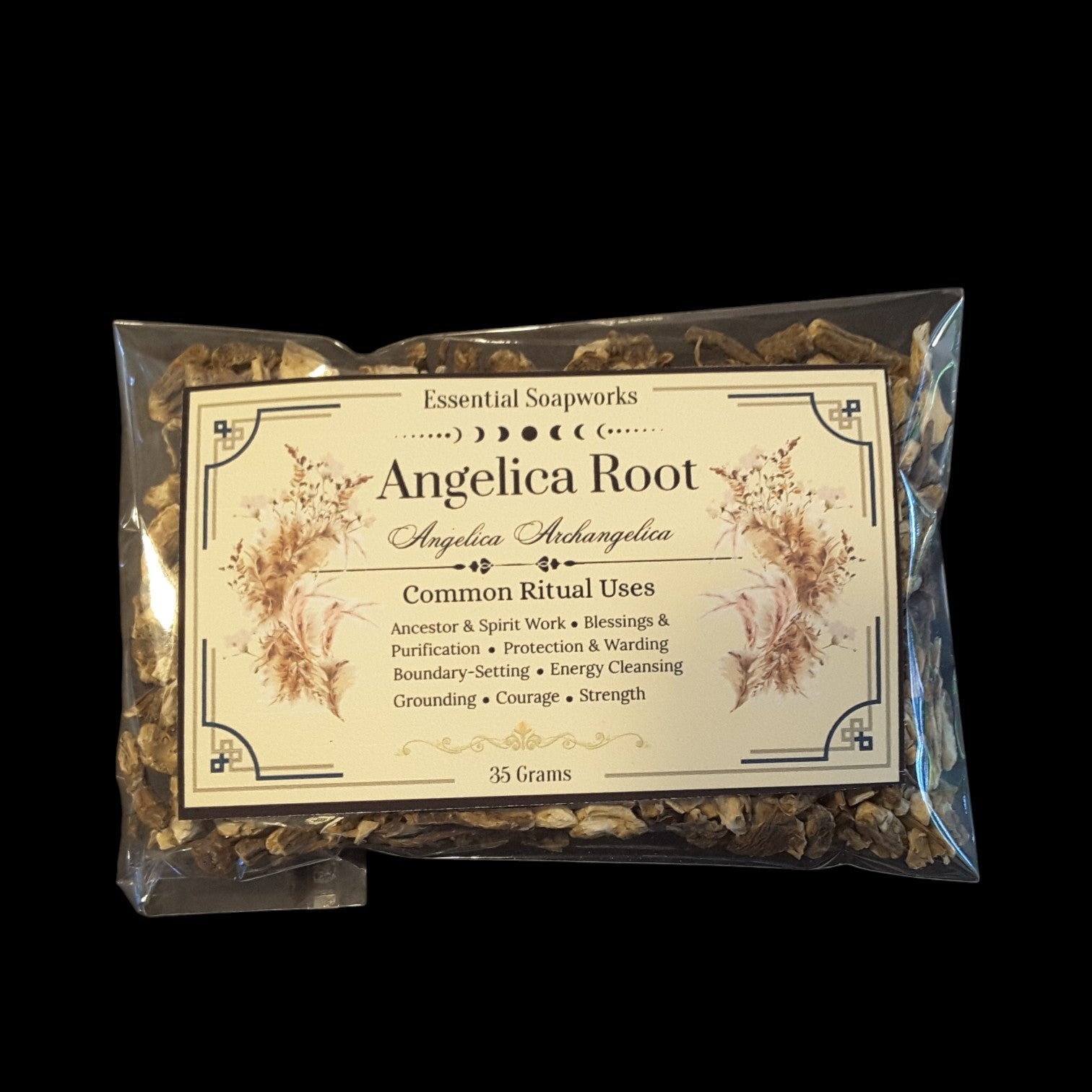 A clear plastic bag of Angelica Root herbal soap blend by Essential Soapworks, featuring a cream-colored label with decorative borders and text, set against a solid black background.