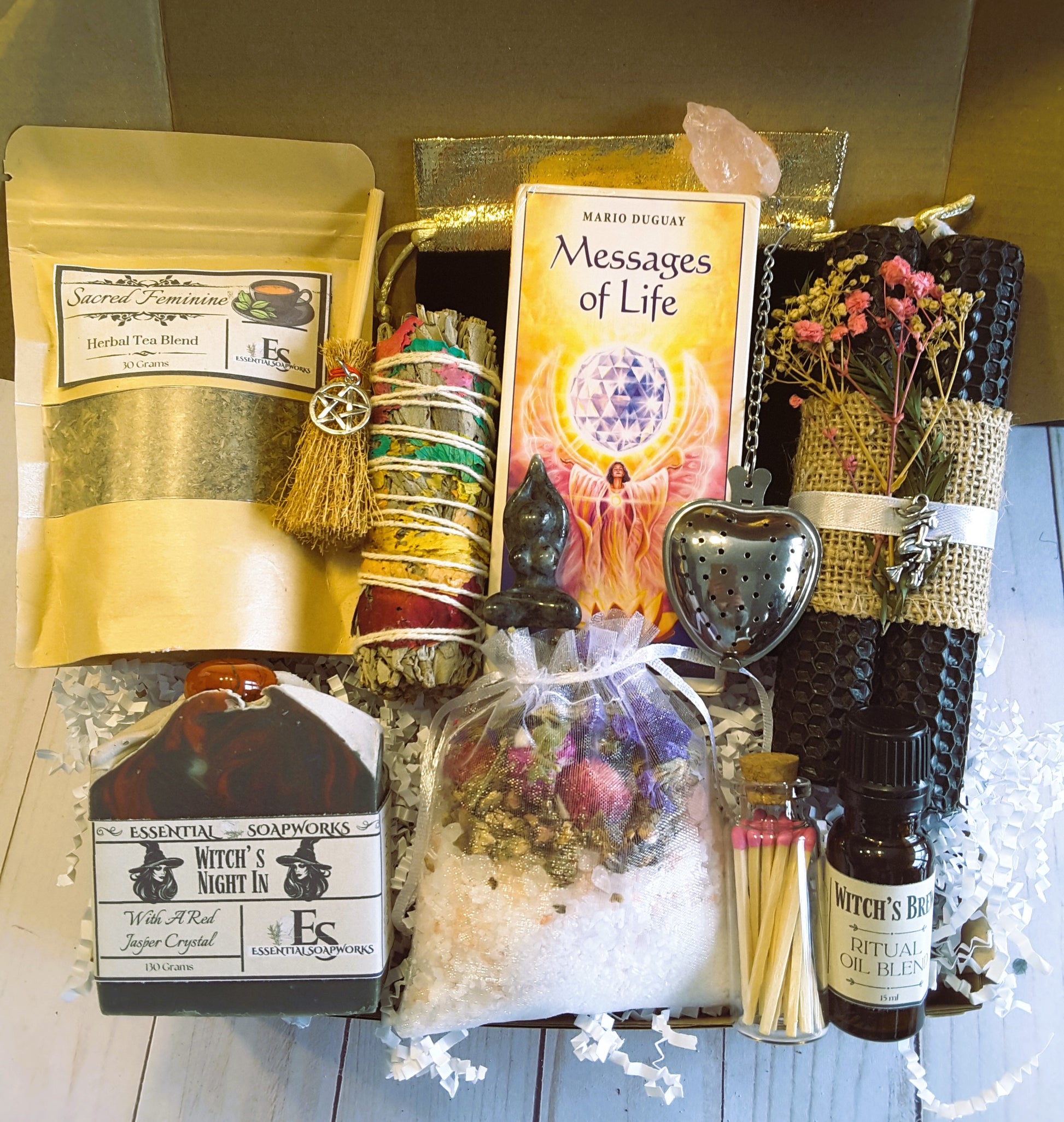 Witch's Self-Care Kit with witchcraft-themed items including Messages of Life oracle cards crystals, and bath salts on a wooden surface.