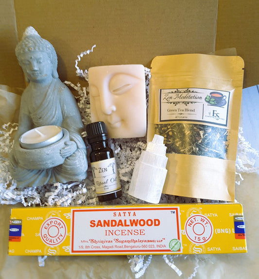 Spiritual Self-Care Mystery Kit including a Buddha statue, candles, essential oil, and sandalwood incense in a box.