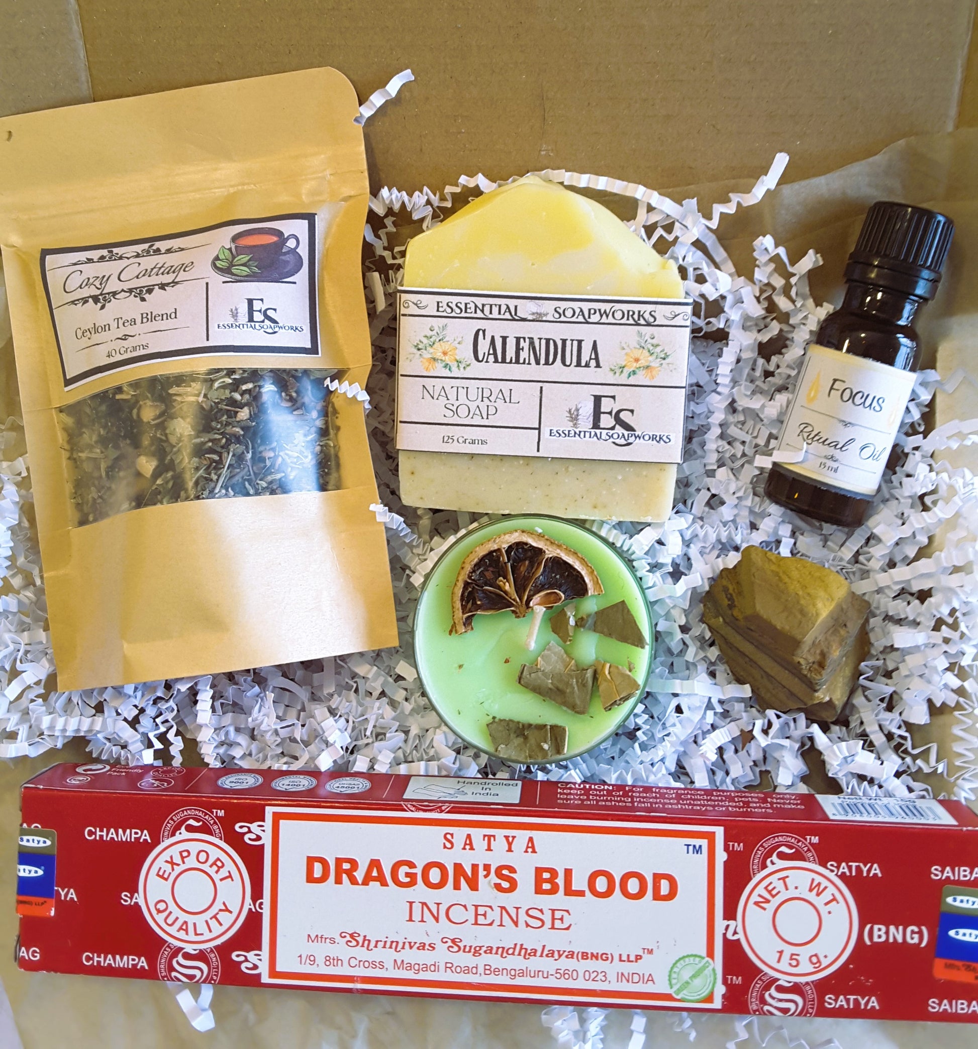 Spiritual Self-Care Mystery Kit including tea, soap, essential oil, and incense in a box.