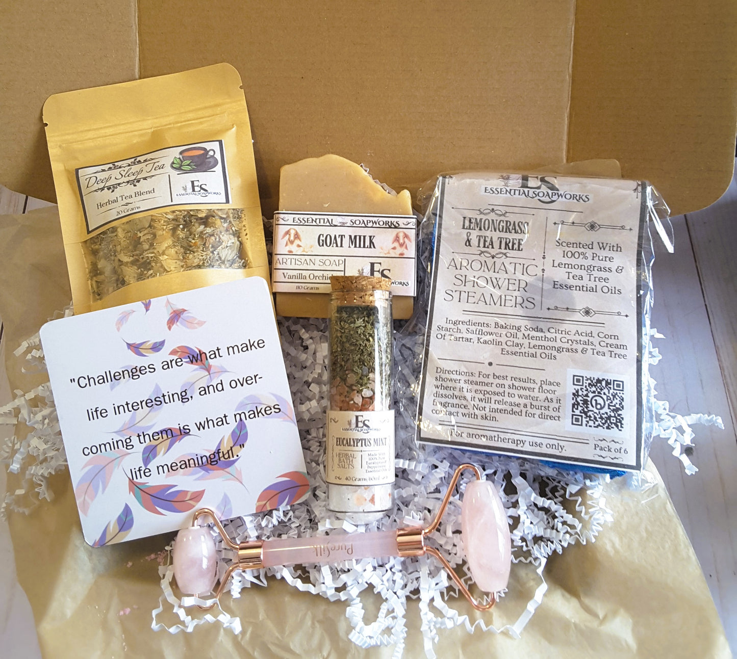 Holistic Self-Care Mystery Kit including a tea, soap, and bath items on a wooden surface.