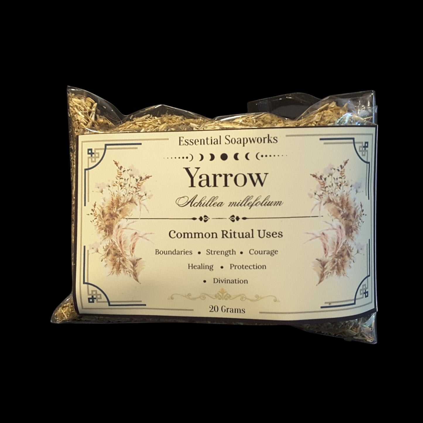A 20g package of Yarrow dried herb, featuring a cream-colored label with botanical illustrations and text detailing its common ritual uses, set against a solid black background.