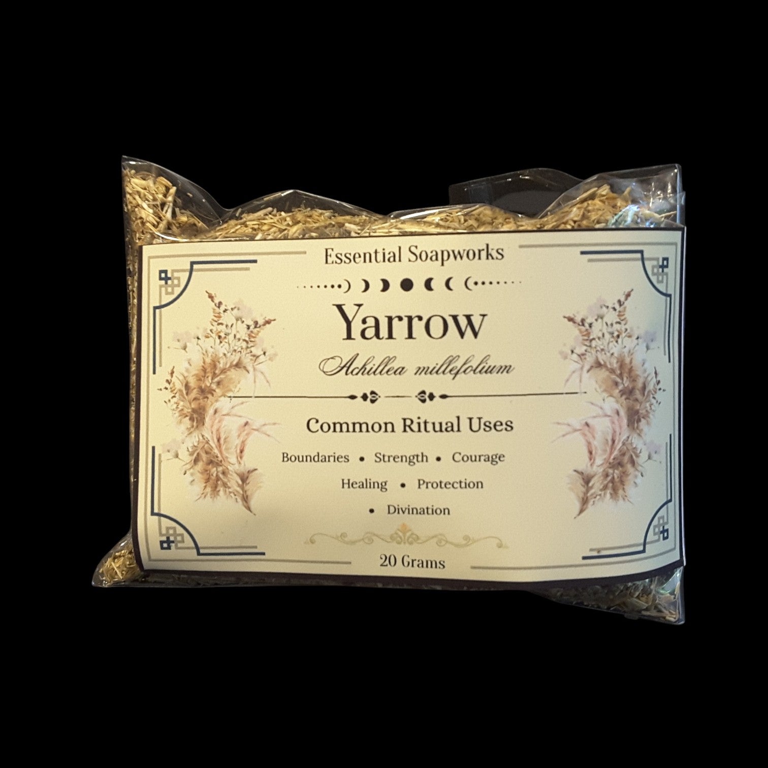 A 20g package of Yarrow dried herb, featuring a cream-colored label with botanical illustrations and text detailing its common ritual uses, set against a solid black background.