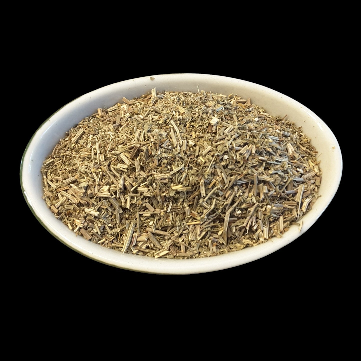 A white oval dish filled with dried vervain for witchcraft, shown against a solid black background.