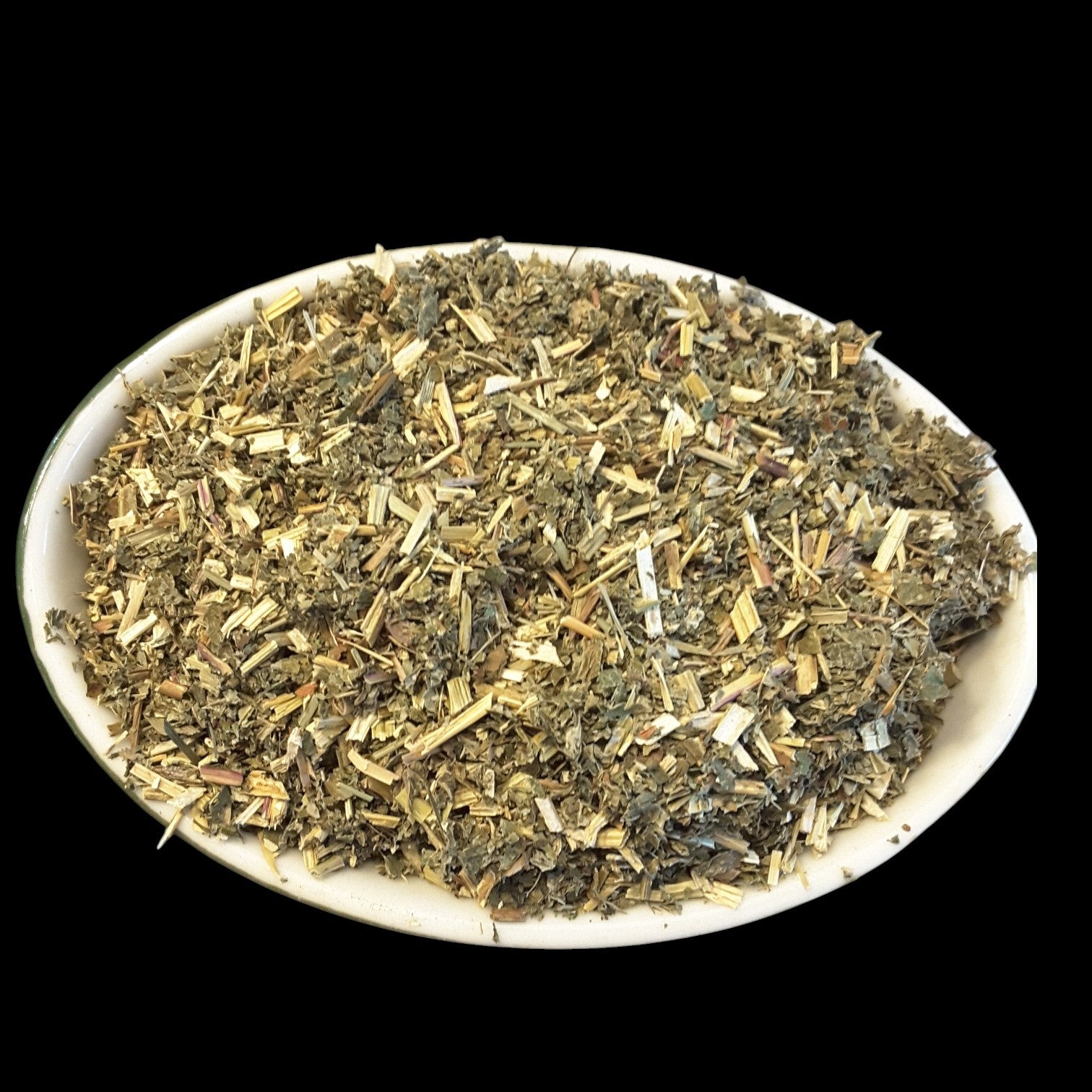 A white oval plate filled with dried meadowsweet, shown against a solid black background.