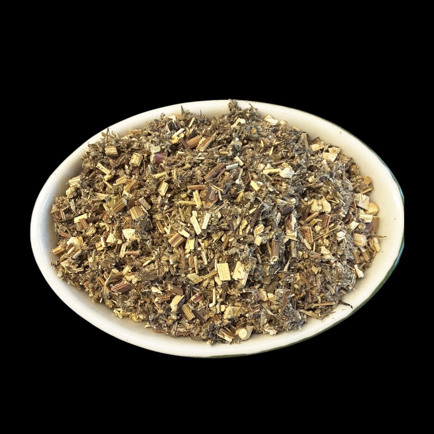 A white oval bowl filled with mugwort herb, photographed against a solid black background.