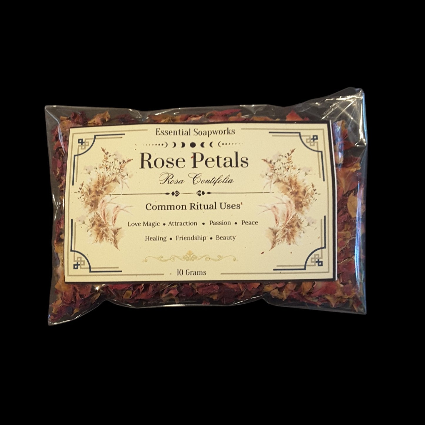 A 10g packet of Rose Petals containing dried rose petals, sealed in a clear plastic bag with a decorative cream-colored label, set against a solid black background.