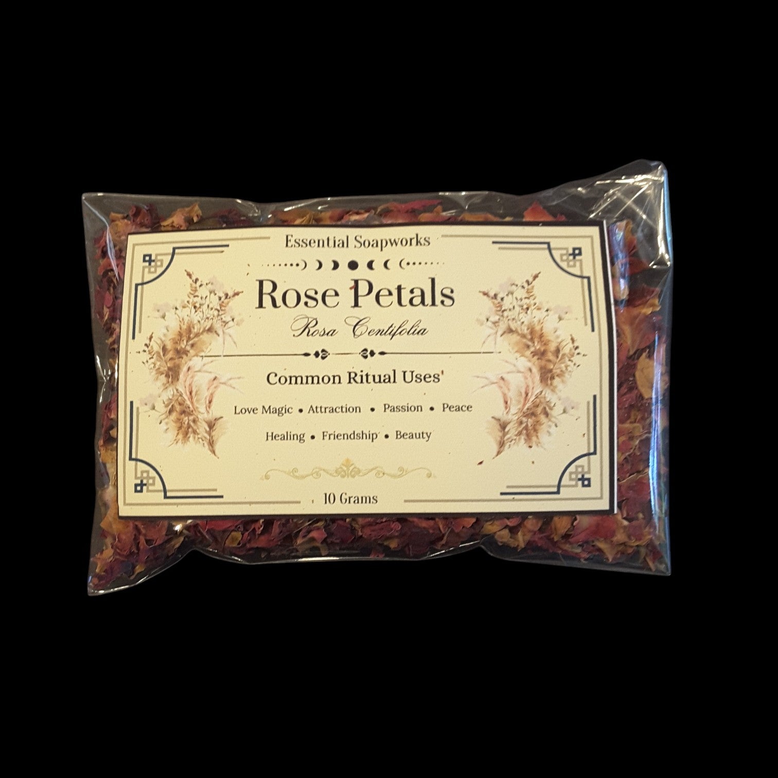 A 10g packet of Rose Petals containing dried rose petals, sealed in a clear plastic bag with a decorative cream-colored label, set against a solid black background.