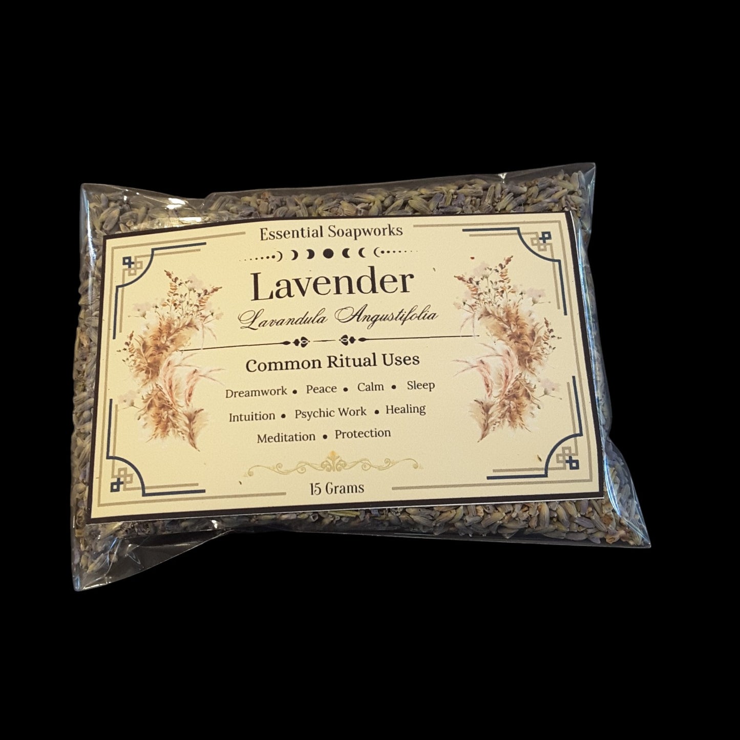A 15g bag of lavender flowers from Essential Soapworks, sealed in a clear plastic bag with a cream-colored label, set against a solid black background.