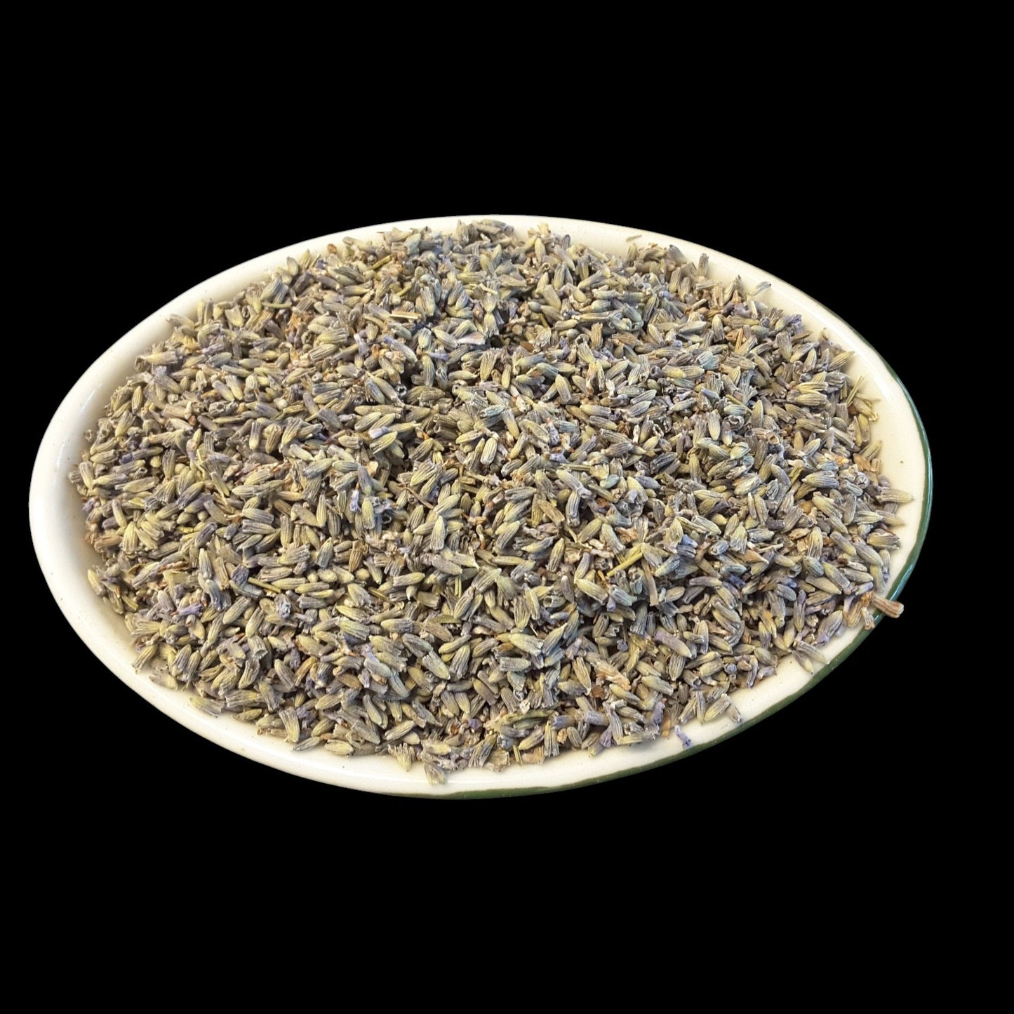 Dried lavender buds piled in a shallow white oval dish against a solid black background.