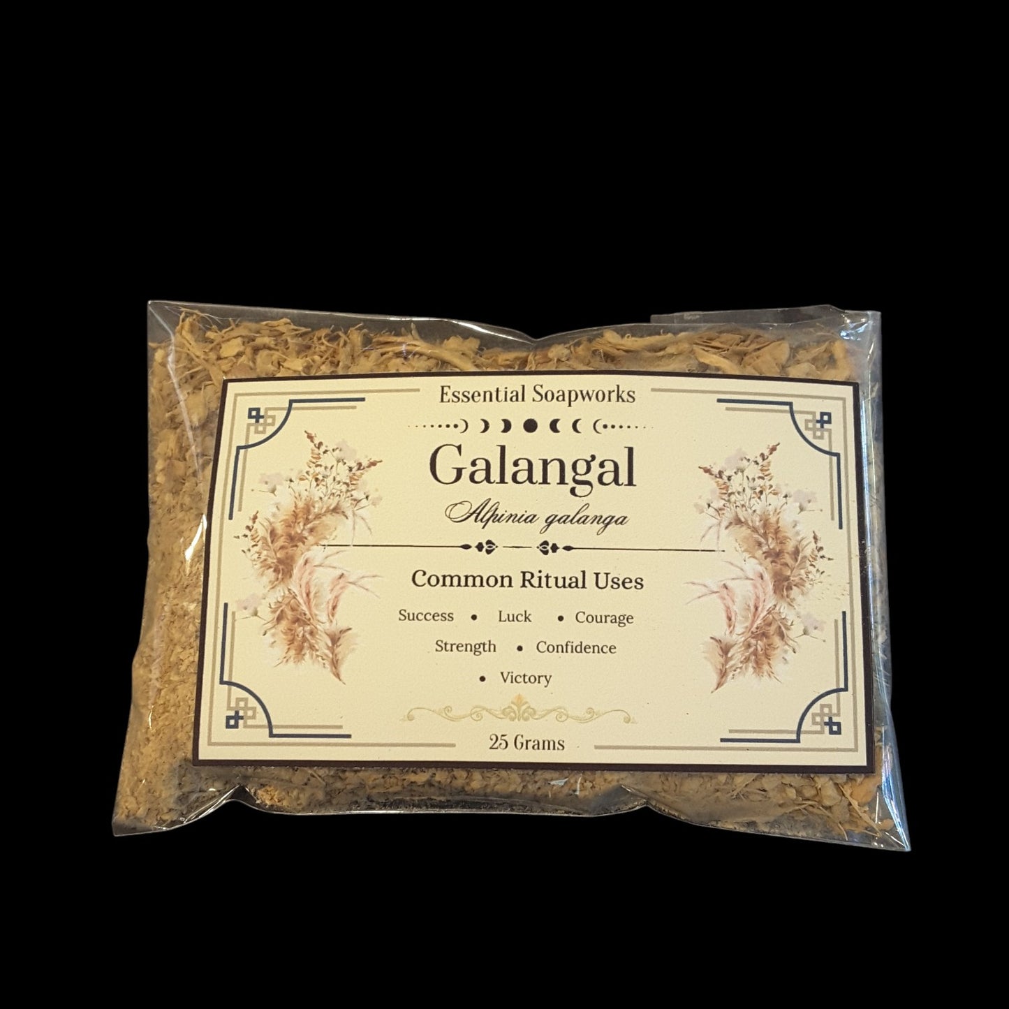 A 25g clear plastic bag of Galangal root showing the dried botanicals inside and a cream-colored label with decorative borders and text, set against a solid black background.