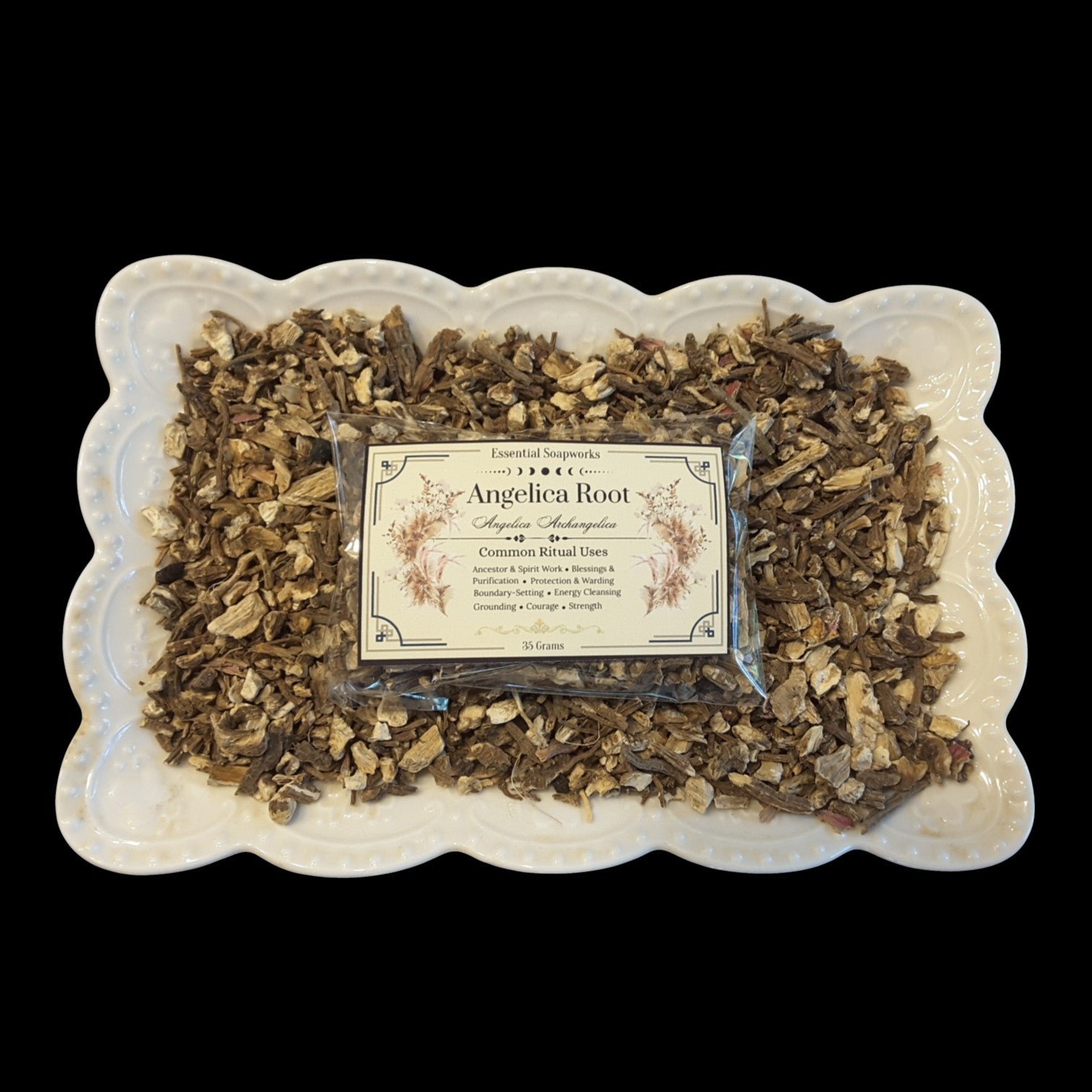 A package of Angelica Root sits in the center of a white scalloped dish filled with dried Angelica roots, set against a solid black background.