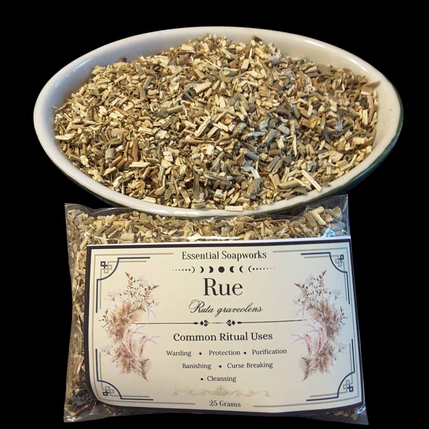 A bowl and bag of dried Rue (Ruta graveolens) botanicals for common ritual use, with the brand 'Essential Soapworks' visible on the label.