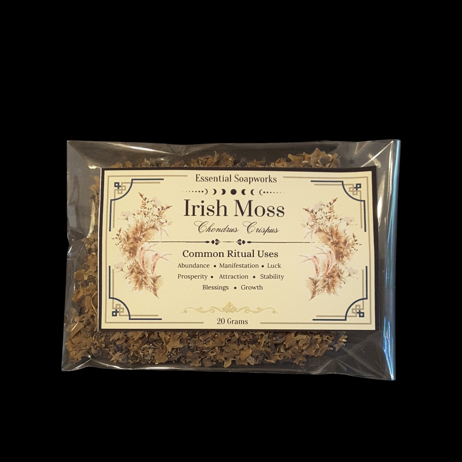 A clear plastic bag containing dried Irish Moss, with a cream-colored label featuring floral illustrations and text that reads 'Essential Soapworks Irish Moss'. The product is photographed against a solid black background.