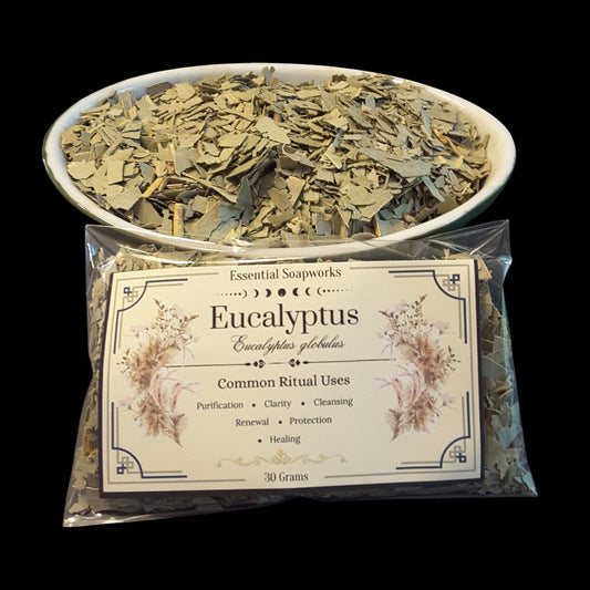 A 30g bag of Eucalyptus dried botanicals from Essential Soapworks, shown in front of a white bowl filled with the same dried leaves, set against a solid black background.