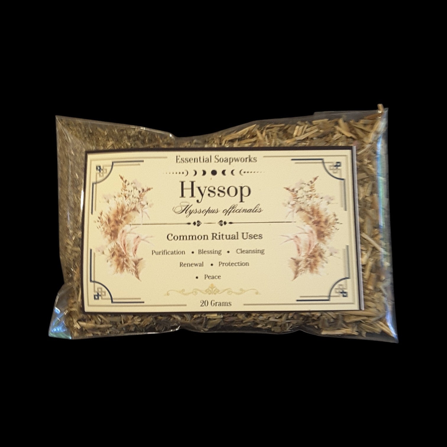 A 20g clear plastic bag of Hyssop dried herbs by Essential Soapworks, featuring a cream-colored label with botanical illustrations, set against a solid black background.
