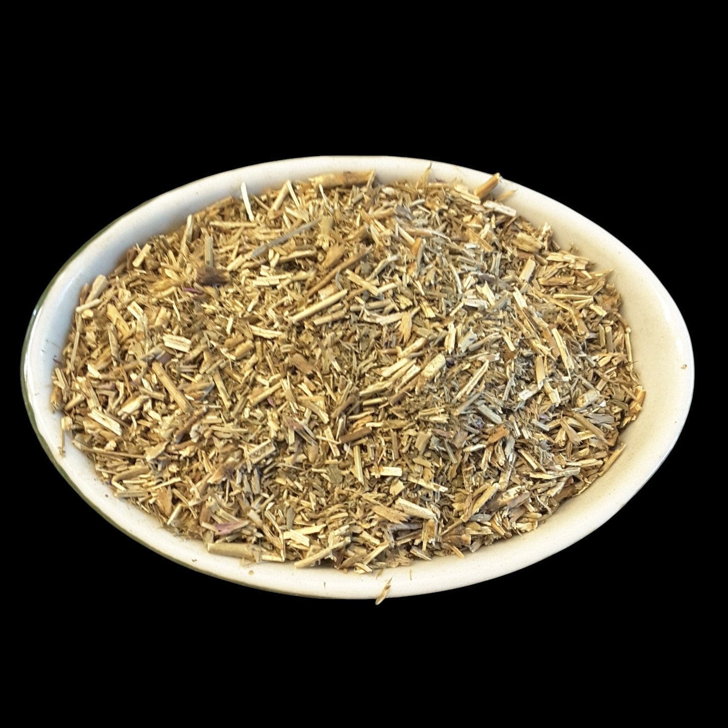 A white oval bowl filled with dried hyssop set against a solid black background.