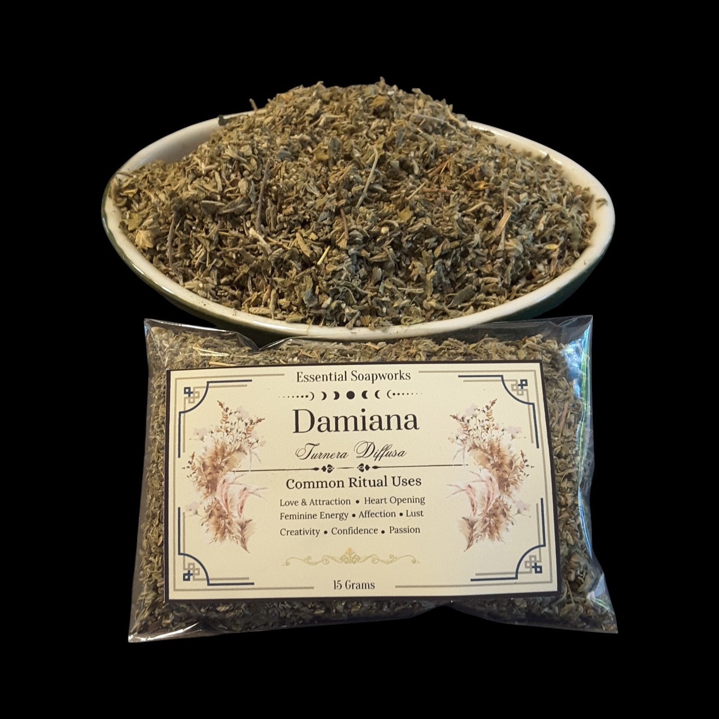 Damiana herb by Essential Soapworks, shown as a clear plastic bag with a cream label in front of a white bowl filled with damiana set against a solid black background.