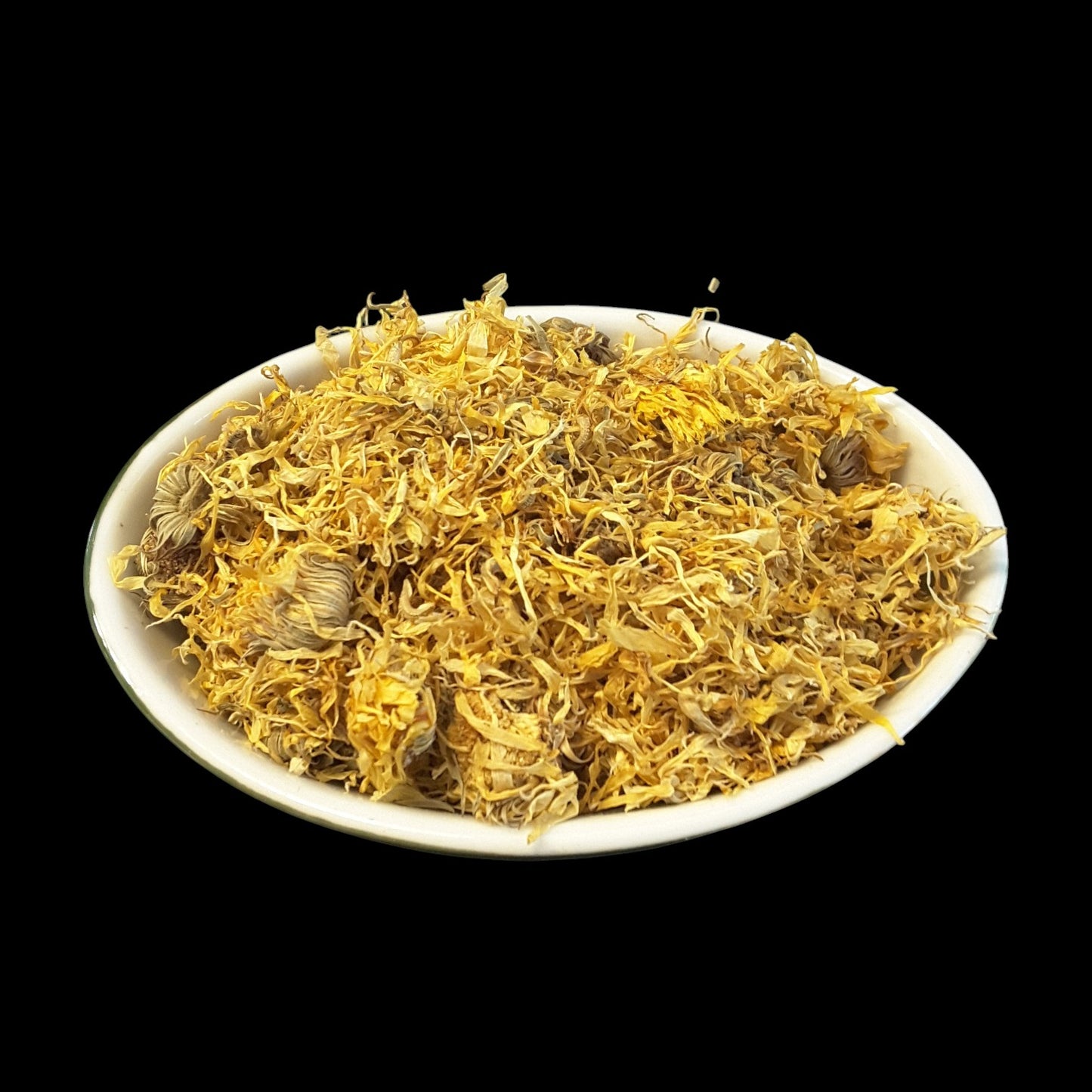 Dried yellow calendula flowers piled in a white shallow bowl against a solid black background.