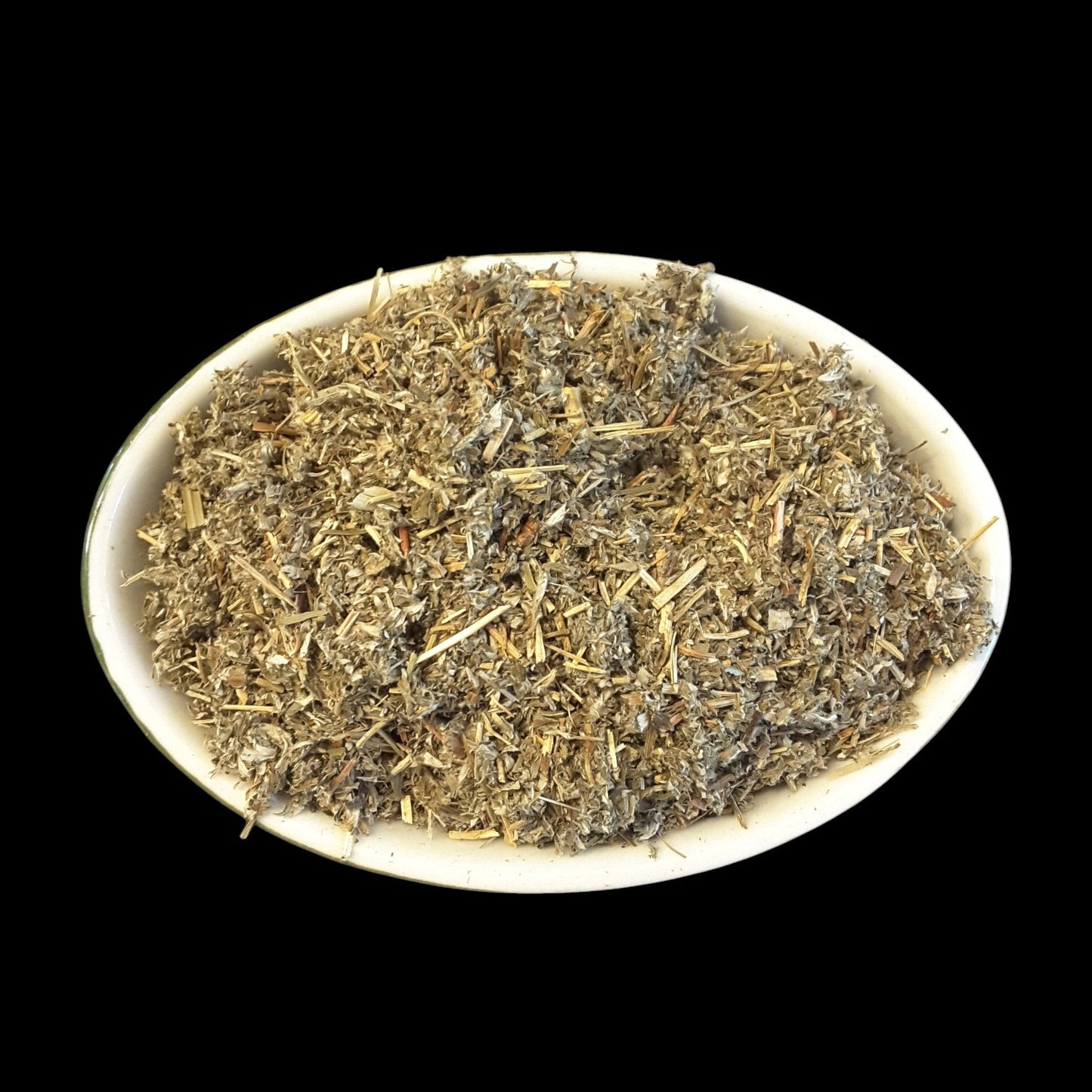 A white oval dish filled with cinquefoil photographed against a solid black background.