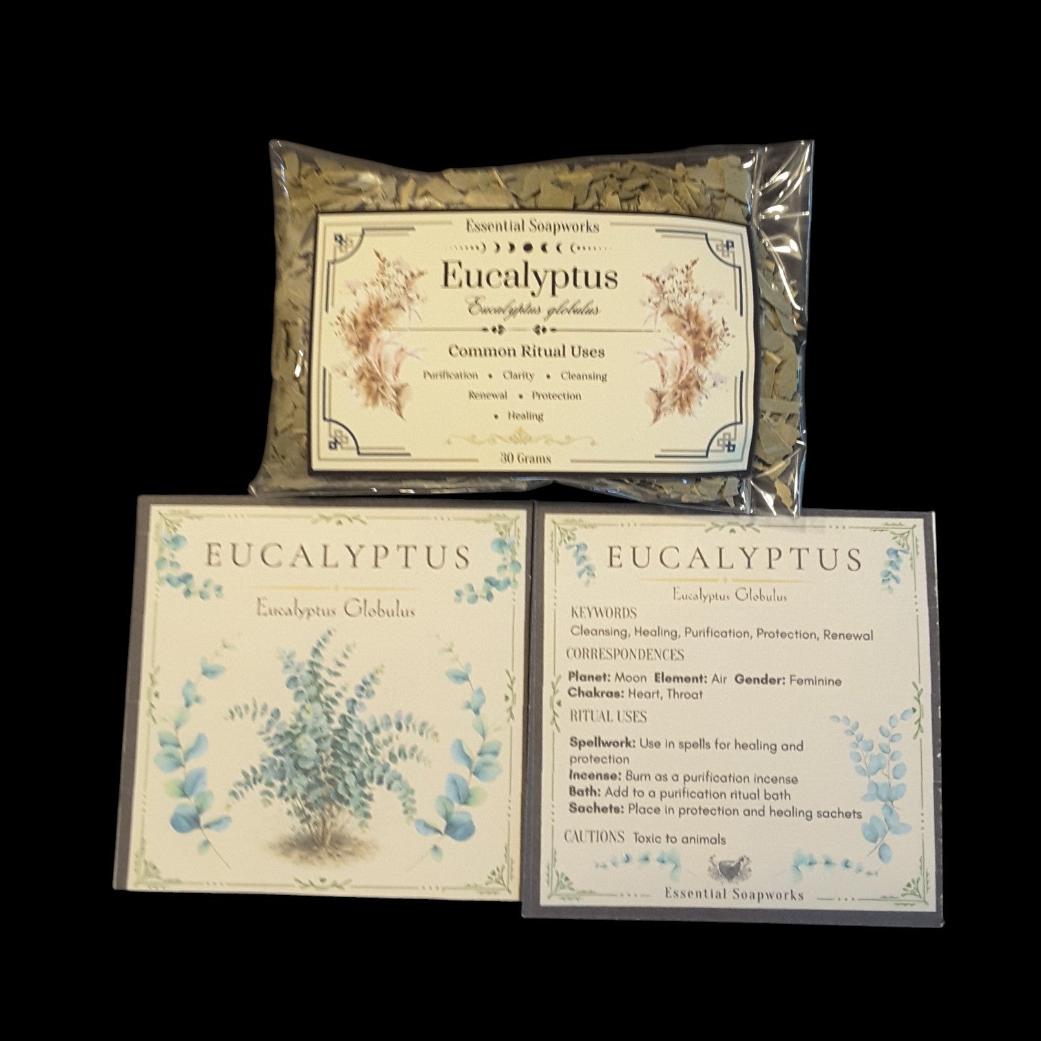 Three product components for Eucalyptus are arranged on a solid black background: a clear plastic bag of dried eucalyptus leaves, and two printed cards showing botanical illustrations and ritual uses