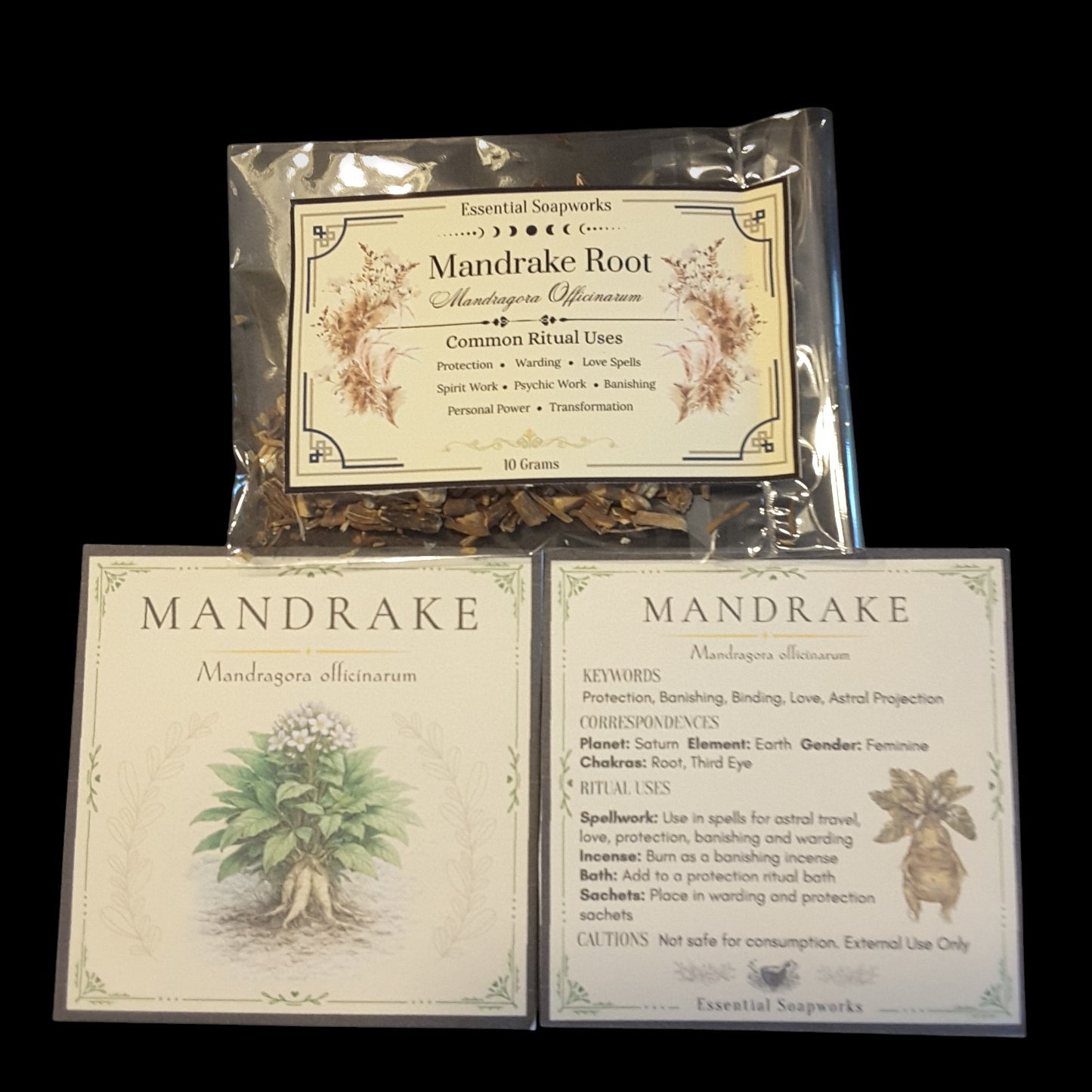 A product display of Essential Sapkarts Mandrake Root, showing a 50g bag of dried roots above two printed cards detailing its spiritual and herbal properties, all set against a solid black background.