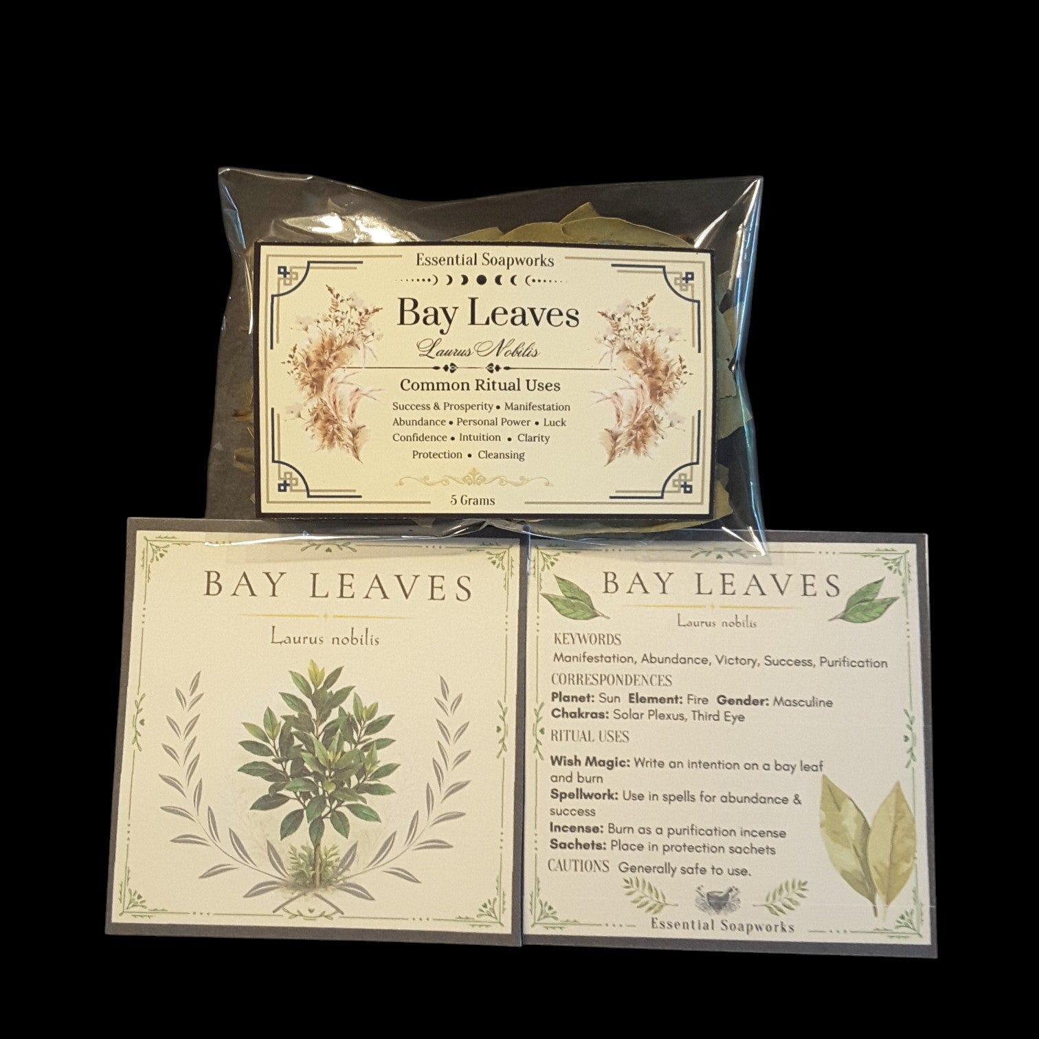Two square product cards for Bay Leaves by Essential Soapworks, displayed on a black background shown flat with printed botanical illustrations and text about spiritual uses, key words, planets, and chakras.