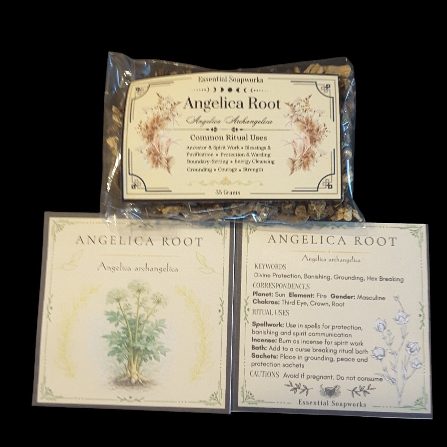 Three product cards and one sealed packet of Angelica Root Essential Soapmarks arranged on a black background. The packet shows dried roots in clear plastic, and the cards display botanical illustrations and ritual information for Angelica arhangelica.