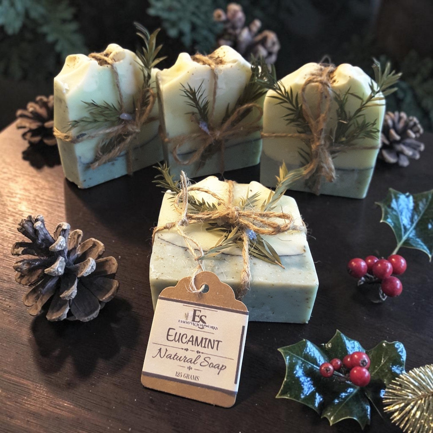 eucalyptus mint christmas botanical soap on a dark wooden surface with pine cones and holly