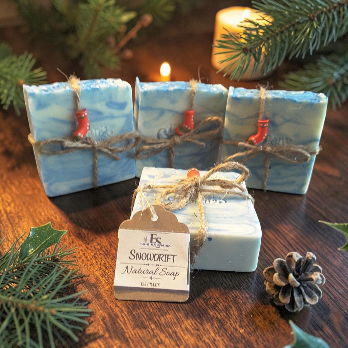 snowdrift christmas soap on a wooden surface with pine cones and pine needles with a candle in the background