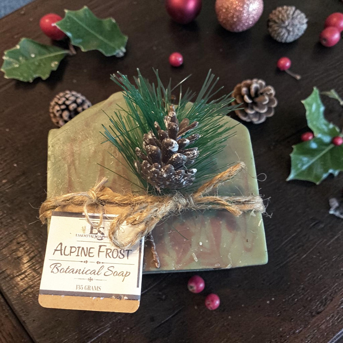 alpine frost christmas soap on a wooden surface with pine cones