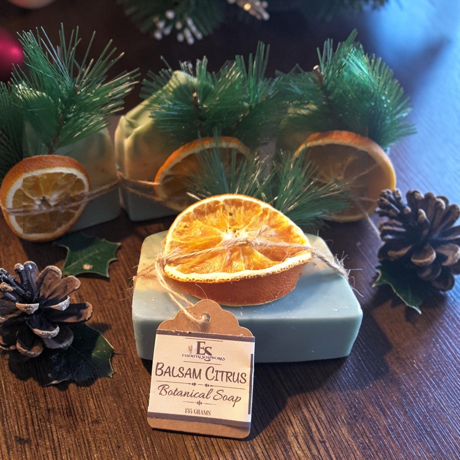balsam citrus festive christmas soap on a wooden surface with pine cones