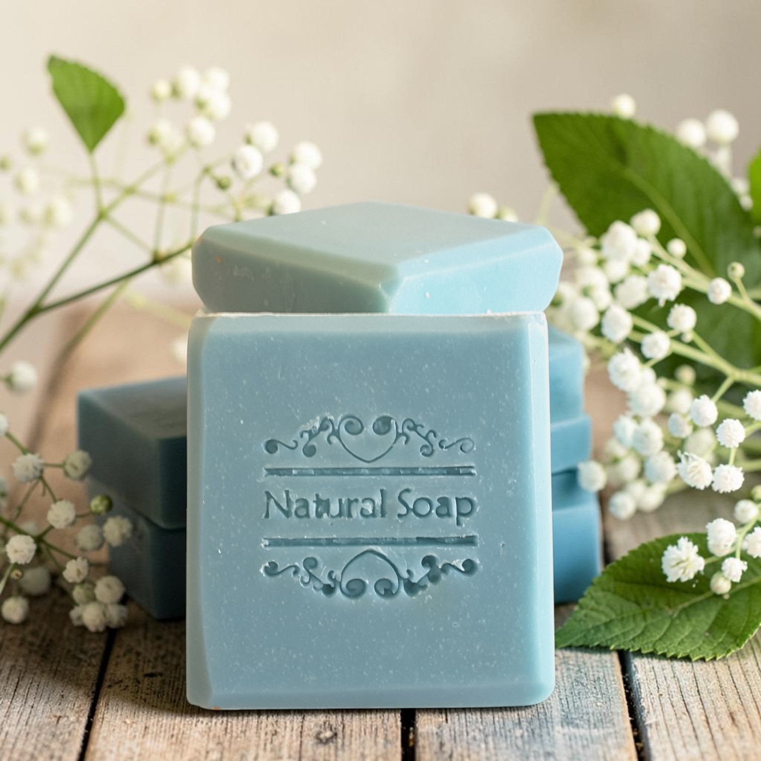 cypress tallow soap on a wooden surface with white flowers
