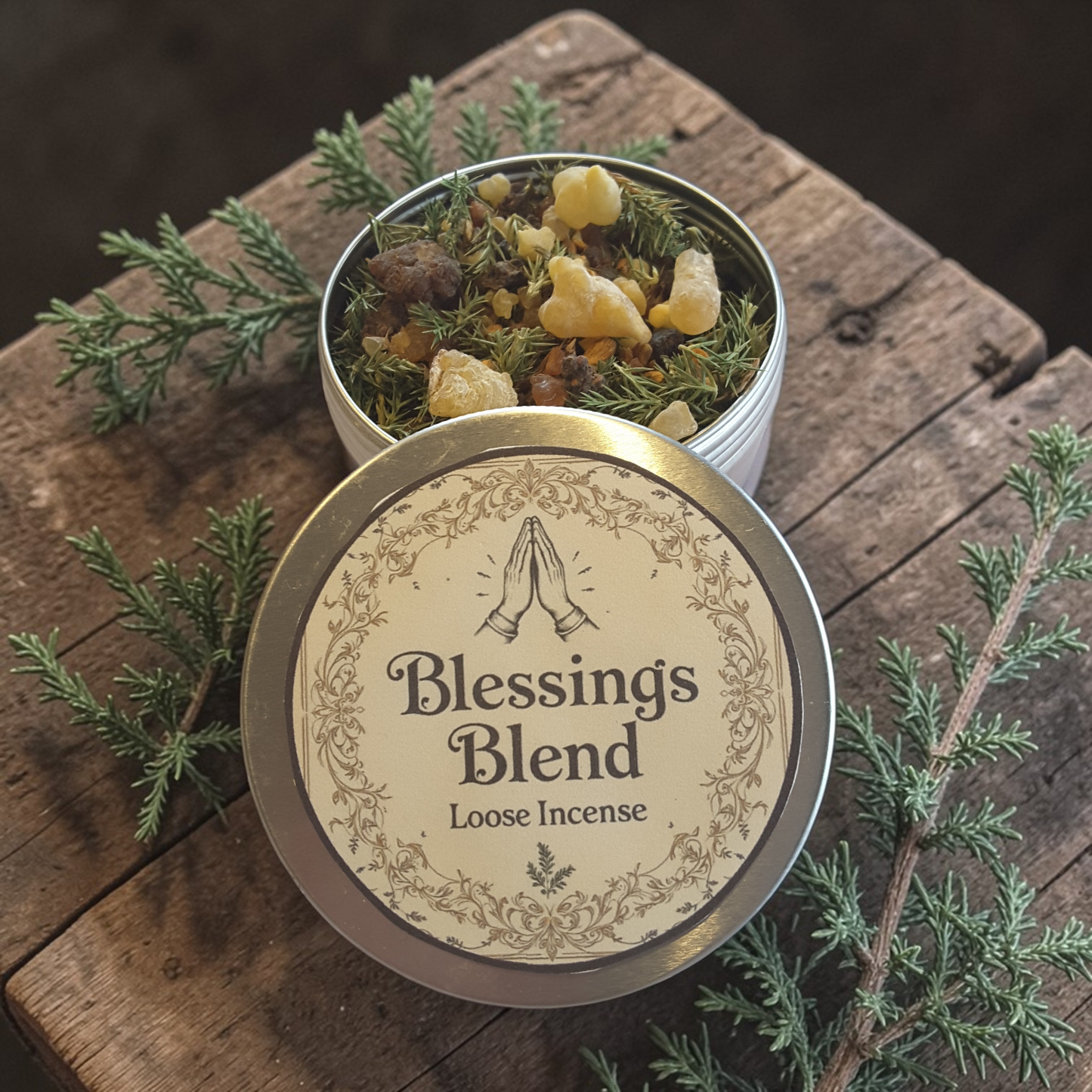 Blessings loose incense on a wooden surface with greenery.