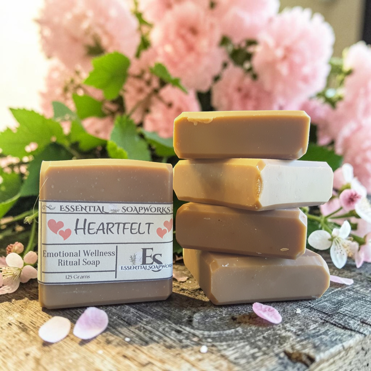 Heartfelt Emotional Wellness Soap on a wooden surface with pink flowers in the background
