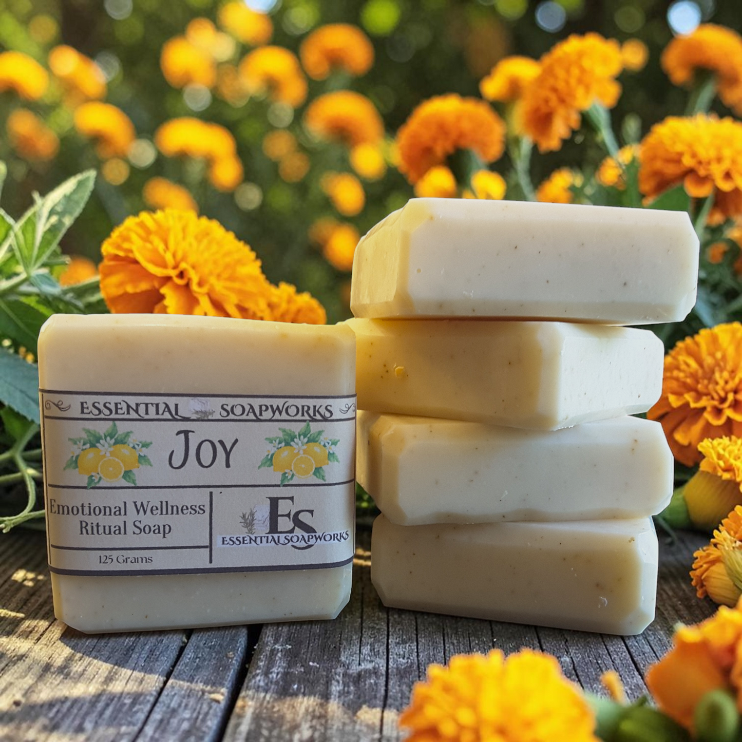 Joy Emotional Wellness Soap surrounded by yellow and orange flowers on a wooden surface