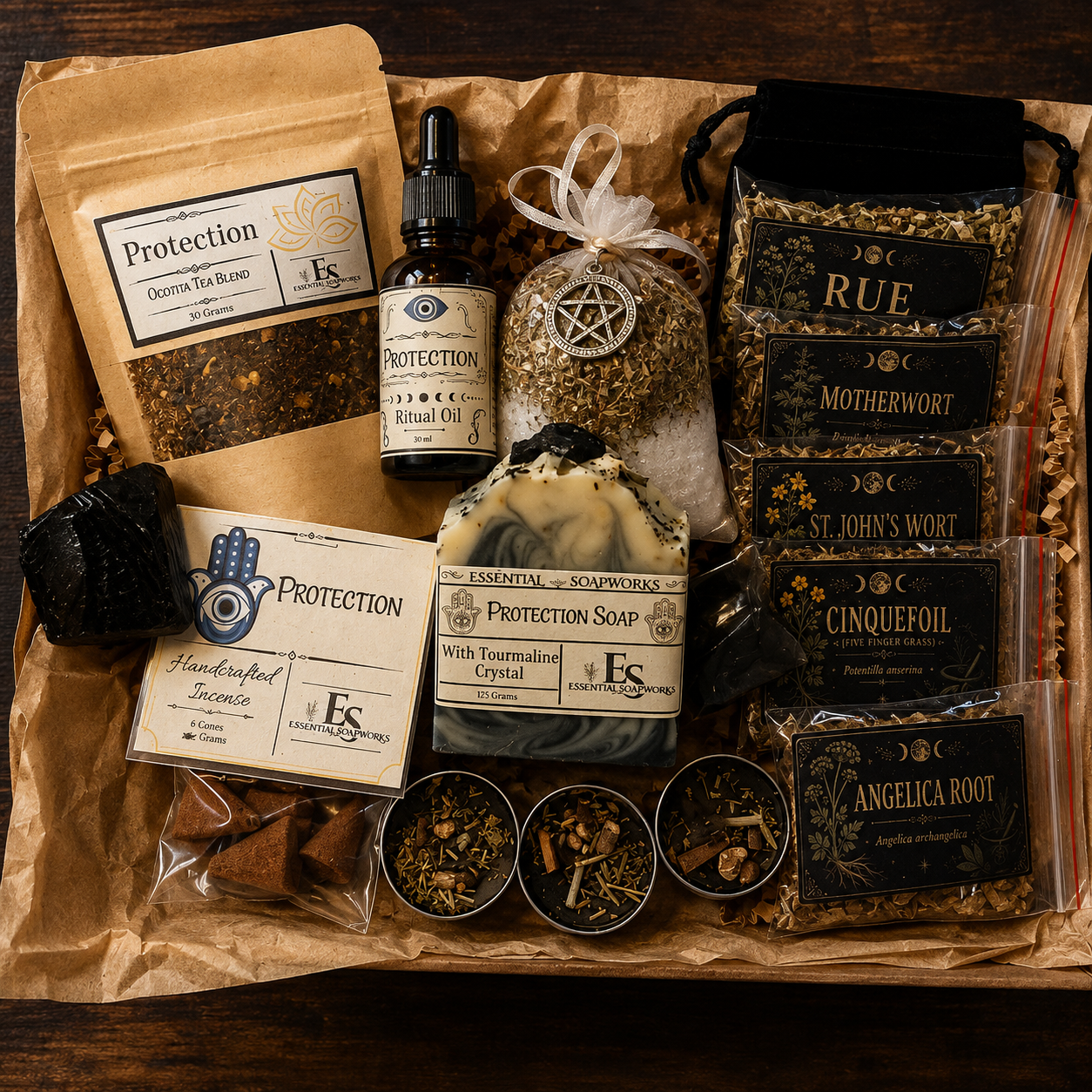 A Samhain Ritual Kit filled with tea, essential oils, soaps, and herbal accessories on a dark wood background. Visible items include multiple bags of herbal tea blends labeled Rue, Motherwort, St.