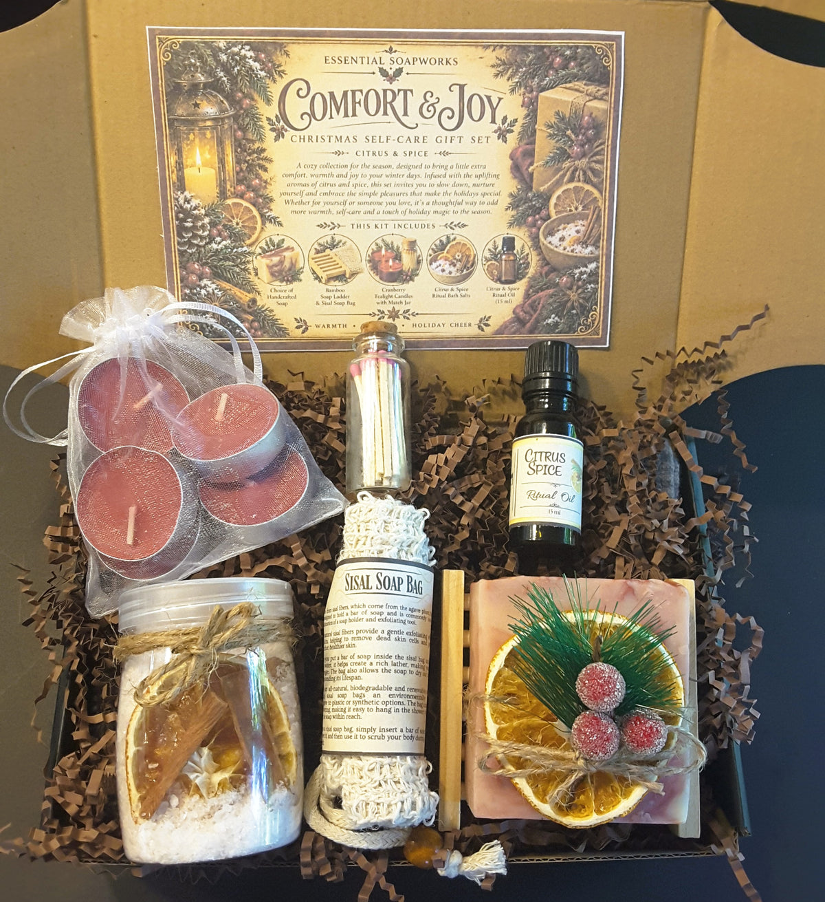 Cranberry Orange Comfort & Joy Christmas self-care gift kit by Essential Soapworks featuring handmade soap, bath salts, cranberry candles, ritual oil and natural bathing accessories.