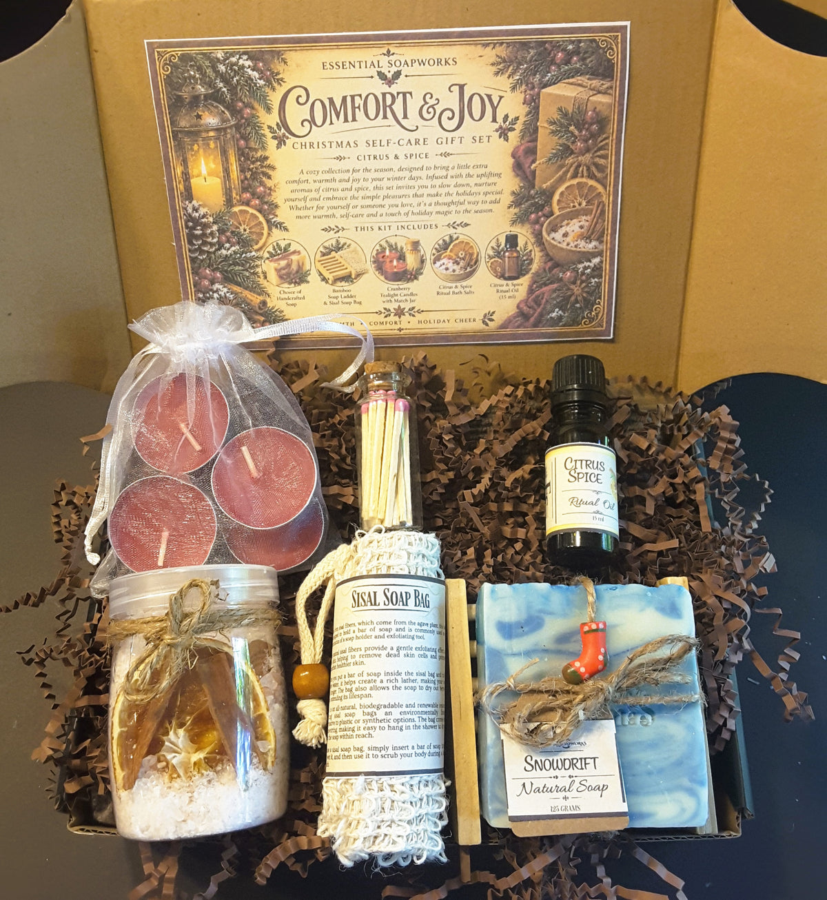 Snowdrift Comfort & Joy Christmas self-care gift kit by Essential Soapworks featuring handmade soap, bath salts, cranberry candles, ritual oil and natural bathing accessories.