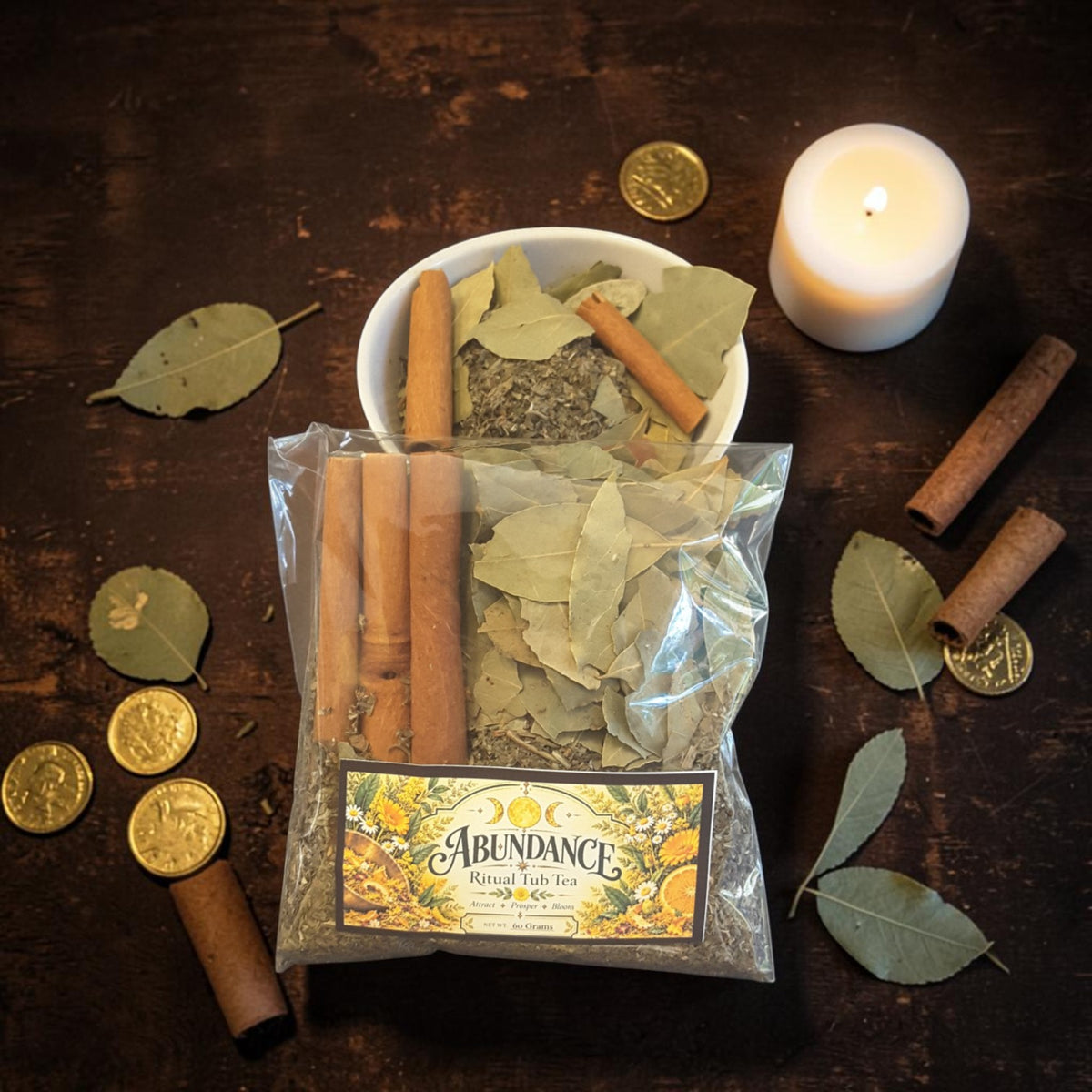 abundance tub tea on a dark wooden surface with gold coins, bay leaves, cinnamon sticks and candles